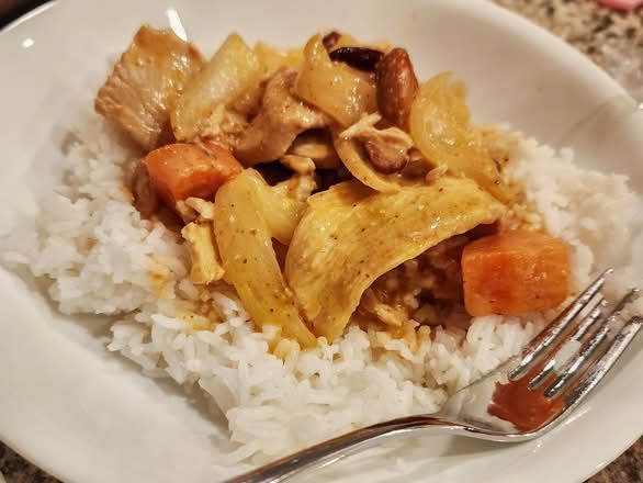 Massaman curry with potatoes and carrots over jasmine rice